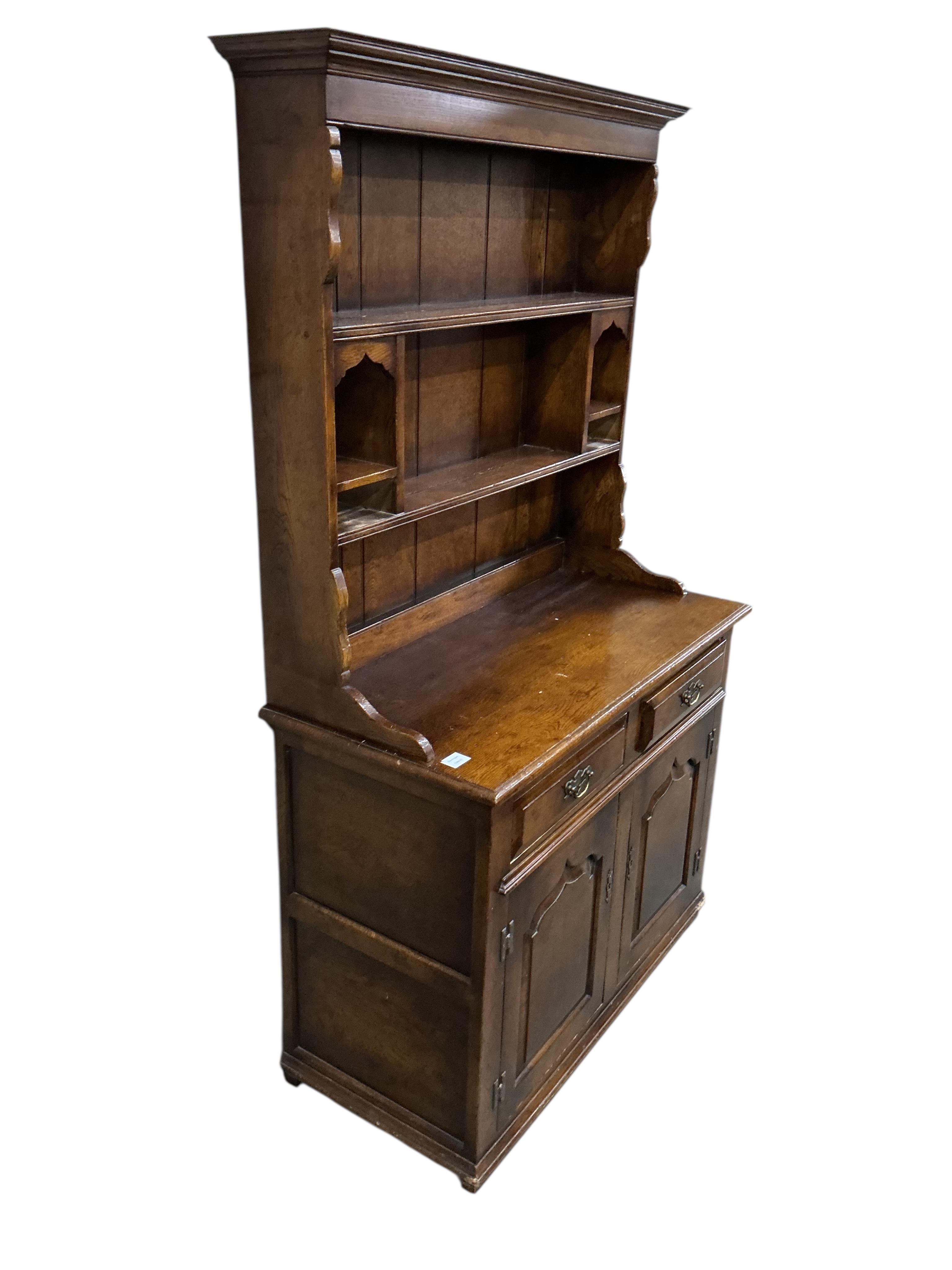 A small 18th century style oak dresser with boarded rack, width 105cm, depth 49cm, height 183cm